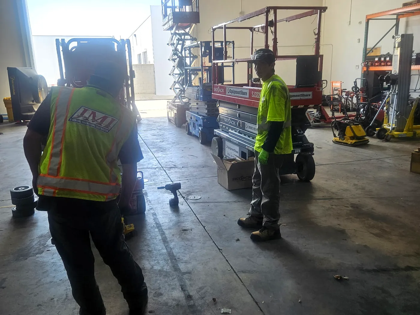 Elite technicians working on lifts and equipment inside the shop