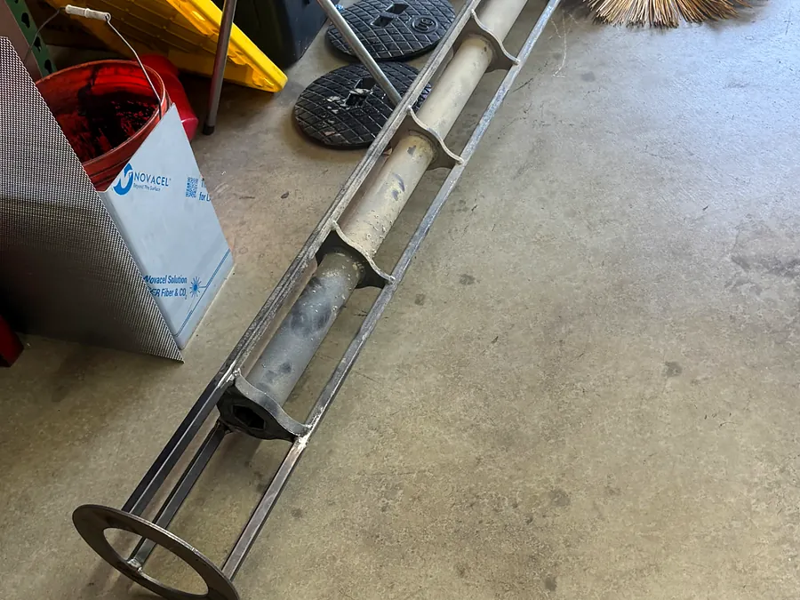 CAT broom attachment auger disassembled in the shop