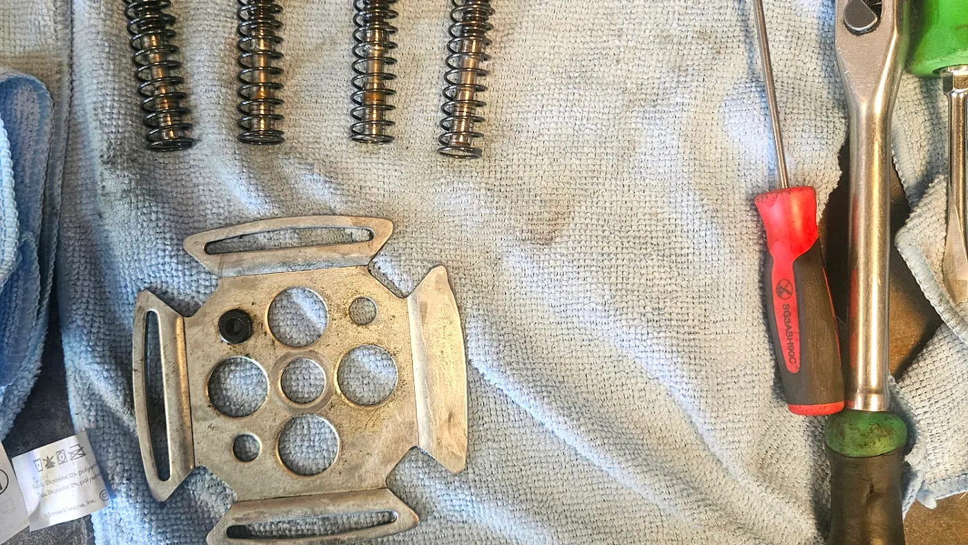 Hydraulic components disassembled and laid out during a shop rebuild