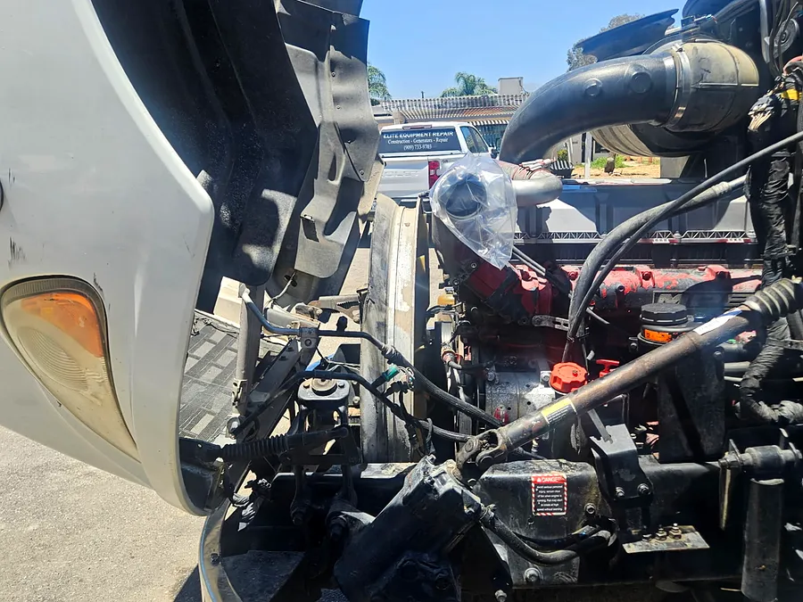 Open truck engine compartment serviced beside the Elite service truck