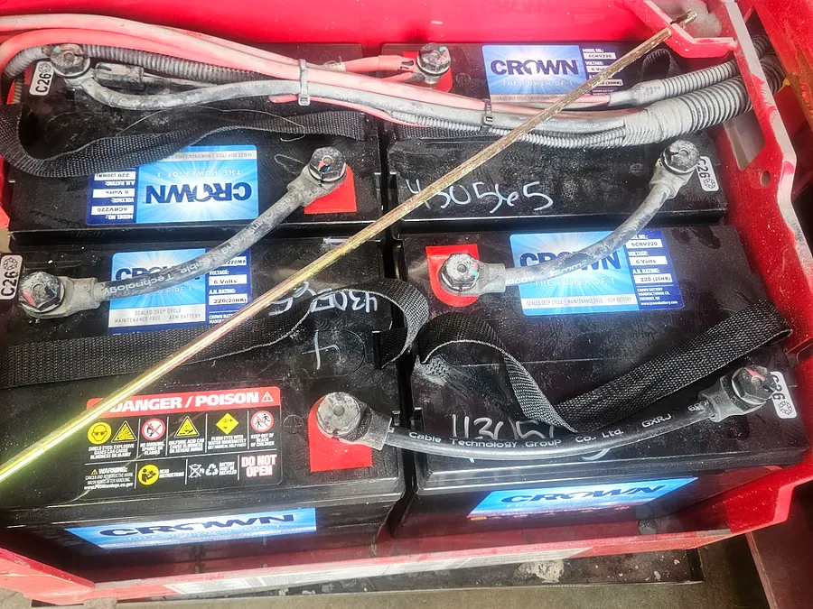 Battery bank serviced inside a machine compartment