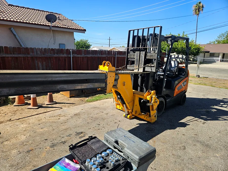 JCB boom positioned with a forklift during repair
