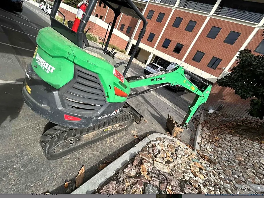 Mini excavator serviced at a commercial property